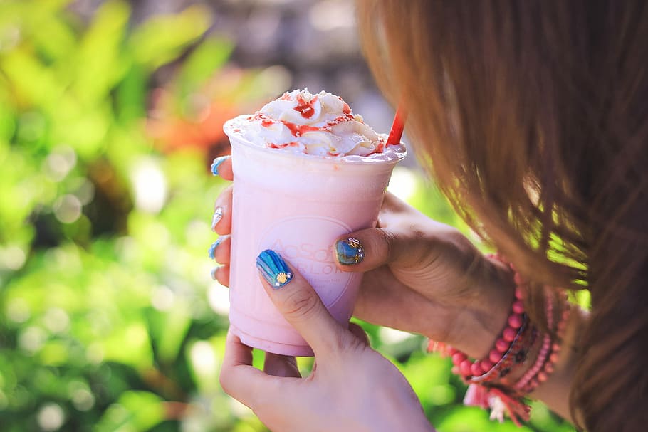 person holding clear plastic cup with pink and white substance HD wallpaper