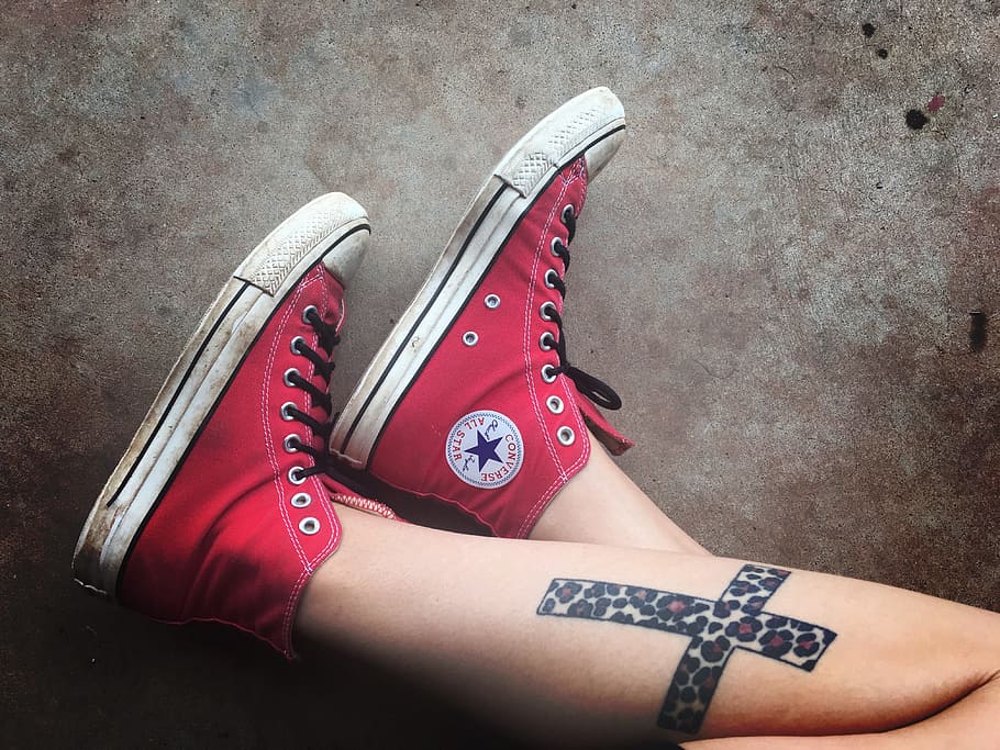 photo of person wearing red Converse Chuck Taylor high-rise, shoes