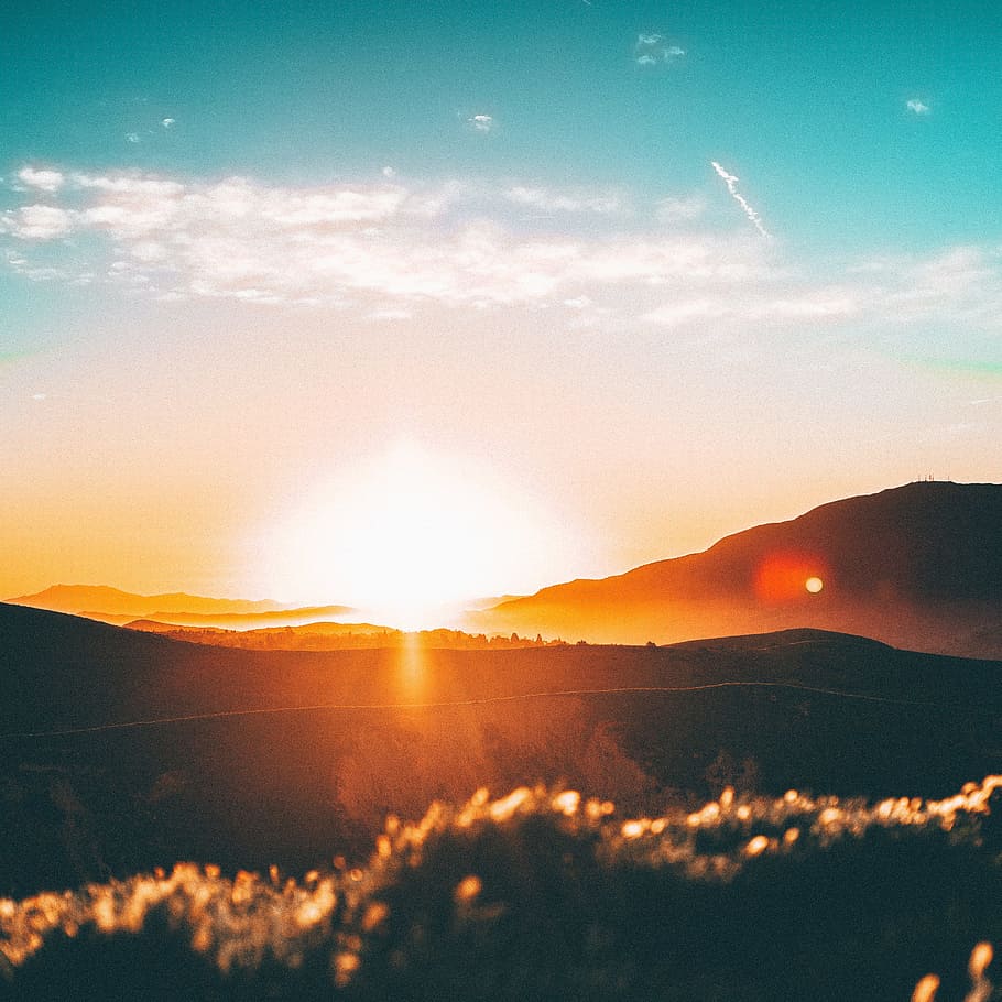 sunset over the horizon, photo of mountains during golden hour HD wallpaper