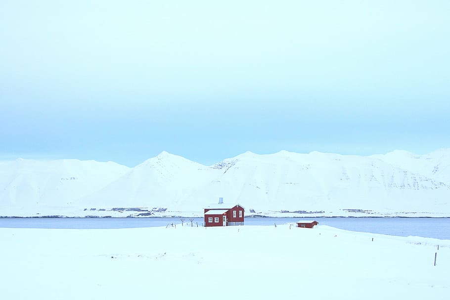photo of ice formation under blue sky at daytime, red and white house beside body of water HD wallpaper