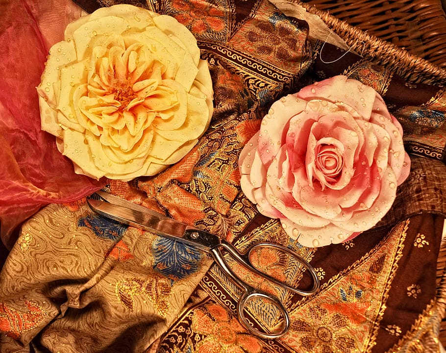 two yellow and pink flower accessories on brown floral textile