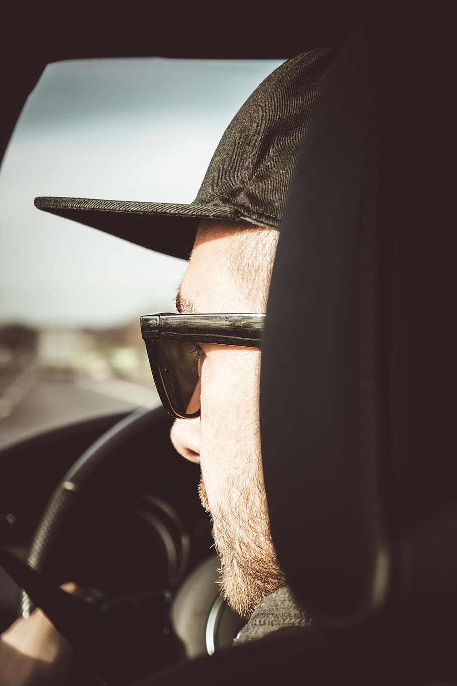 Concentrated, man driving car, male, face, hat, cap, mode of transportation HD wallpaper