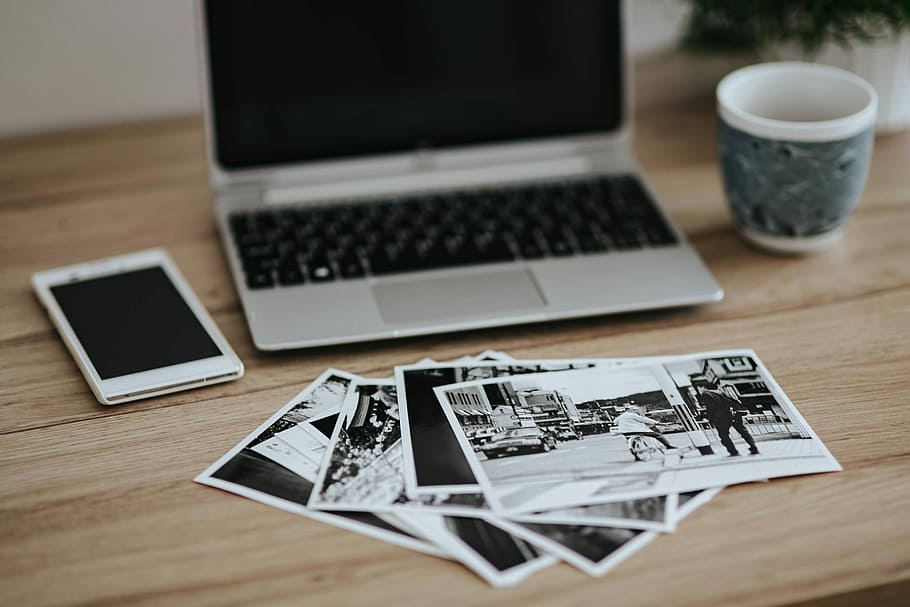 Black-and-white photos with a silver laptop, a smartphone, car keys, pencils and a camera, HD wallpaper