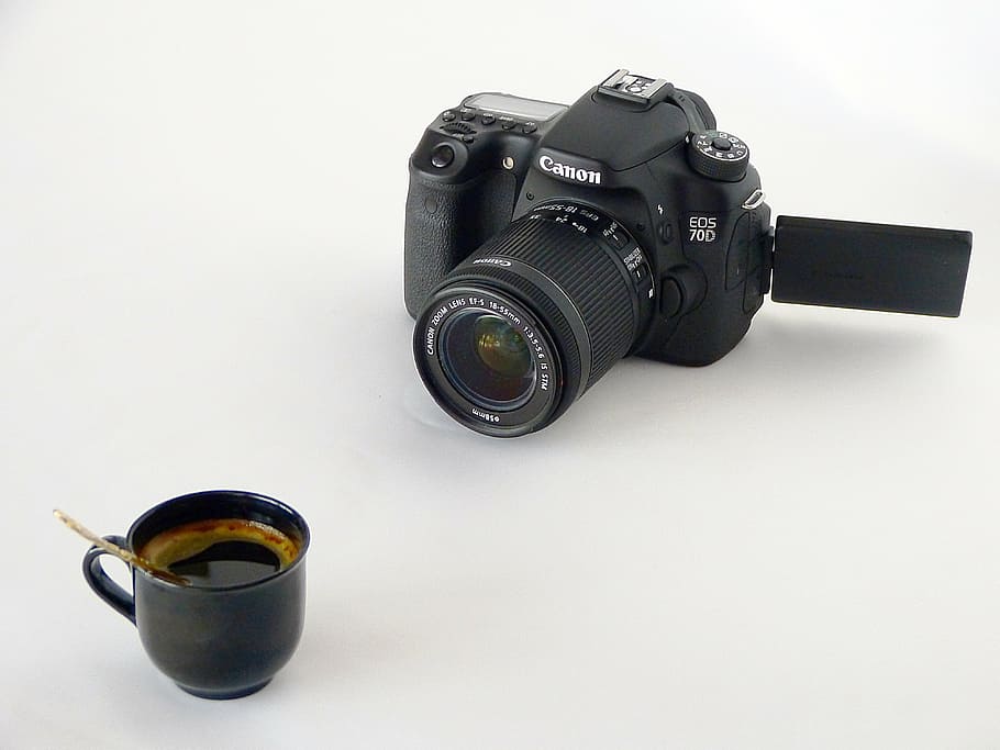 black ceramic coffee cup on white surface near black Canon EOS DSLR camera HD wallpaper