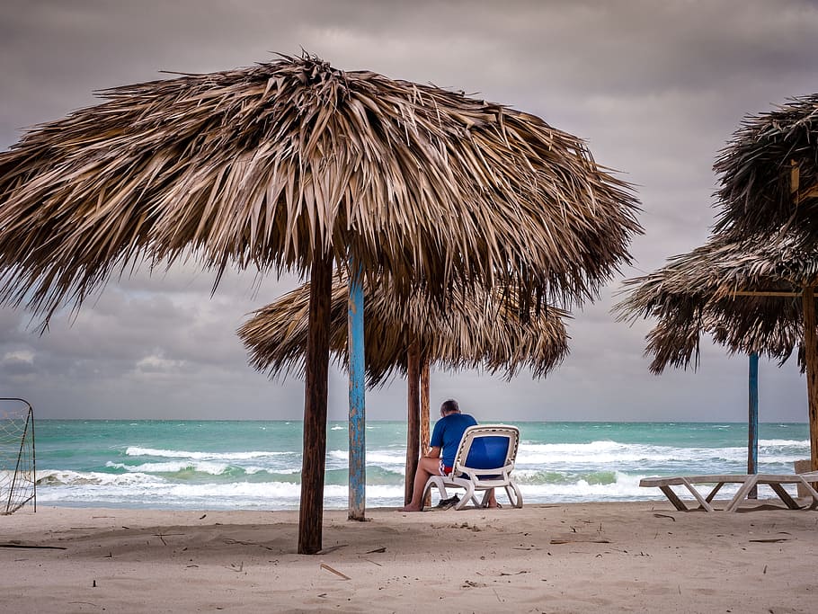 person sitting on white chair, clouds, beach, sea, sky, gloomy HD wallpaper
