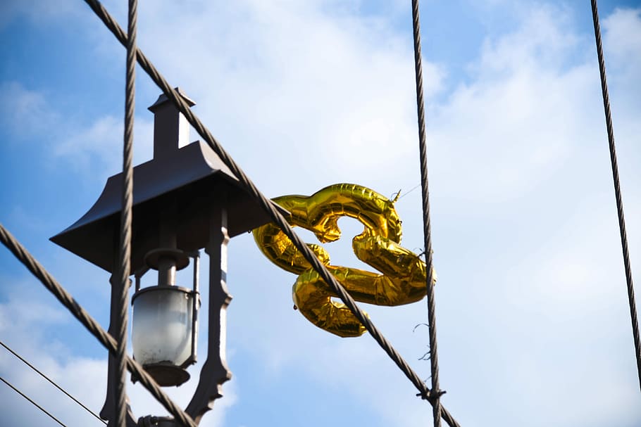yellow 23 shaped balloon reflected at window, black metal outdoor lantern at daytime HD wallpaper
