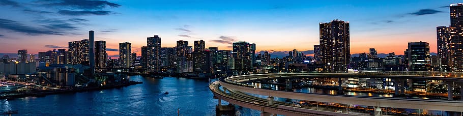 landscape photo of city buildings under the blue sky, rainbow bridge HD wallpaper