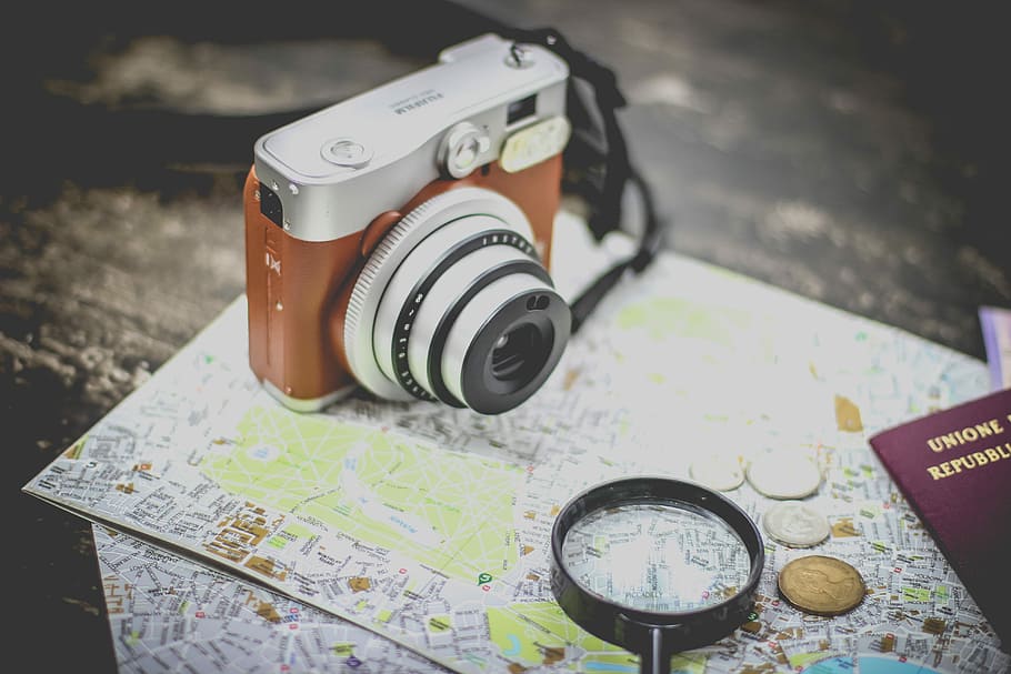 silver point-and-shoot camera on geographical map, silver and brown camera near black magnifying glass HD wallpaper