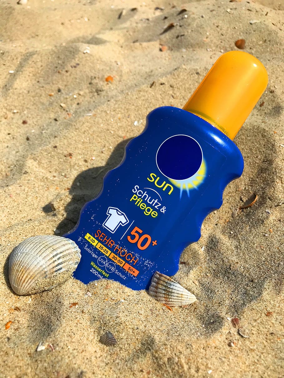 blue and yellow plastic bottle on the sand, Sunscreen, Milk HD wallpaper