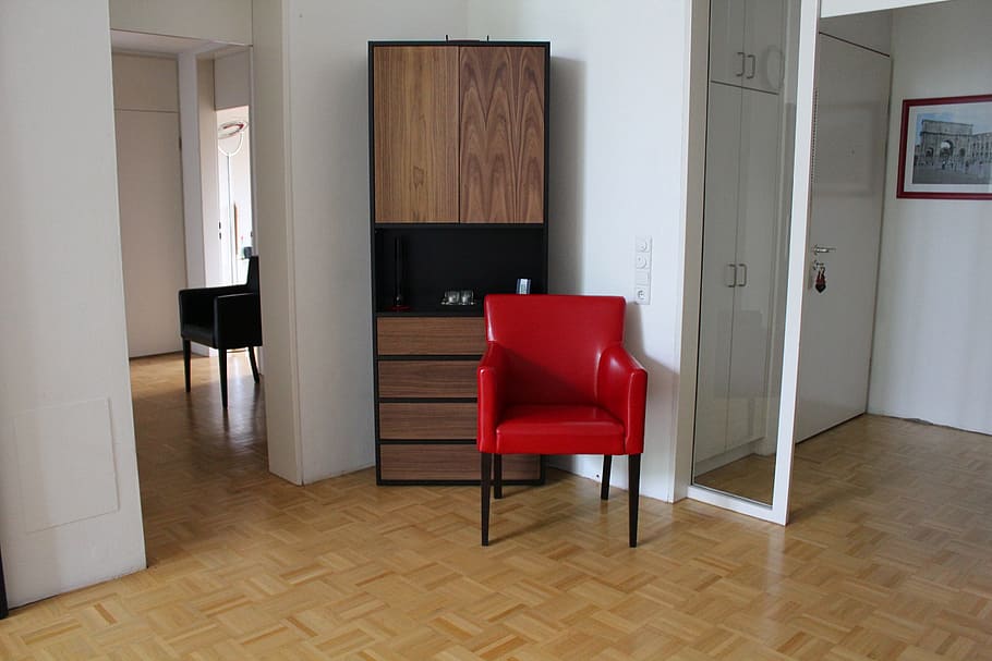 black and red armchair beside brown wooden cabinet, living, room