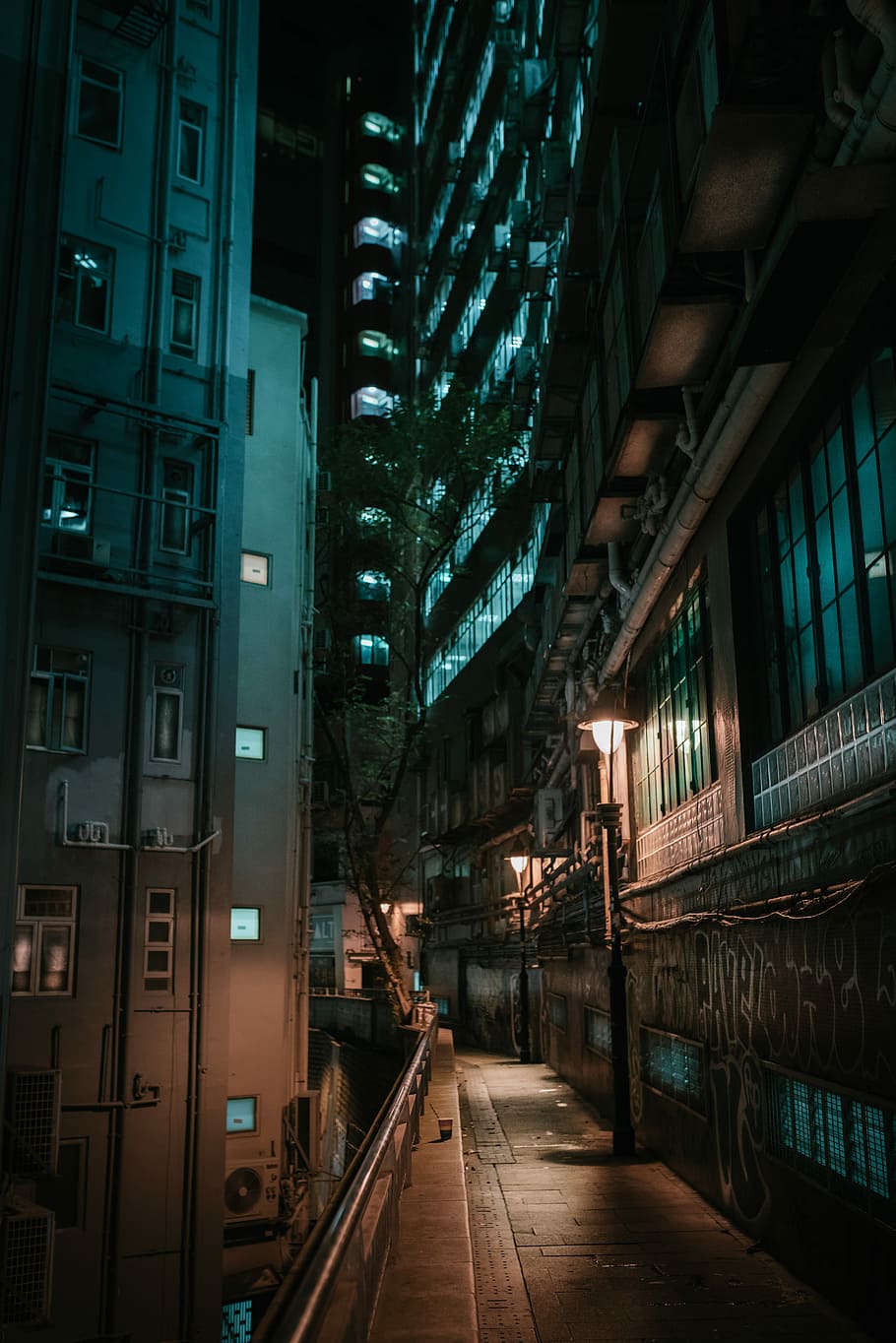 A small alley downtown Hong Kong, grey and brown concrete high-rise building during night time HD wallpaper
