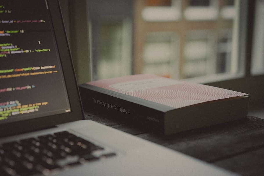 book beside MacBook on top of table, laptop, apple, keyboard HD wallpaper