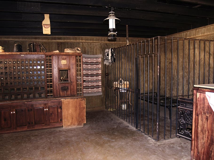 black metal cage beside brown wooden cabinet, jail, bars, old HD wallpaper