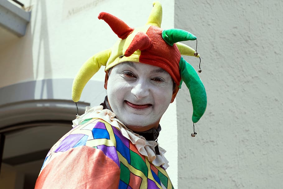 person in clown costume near wall, fool, court jester, funny