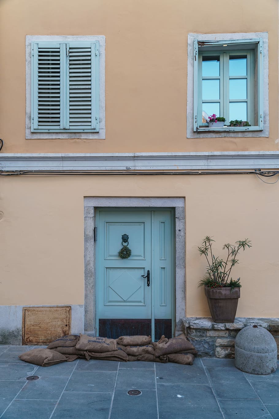 closed door and window, closed blue 2-panel door with sandbags in front HD wallpaper