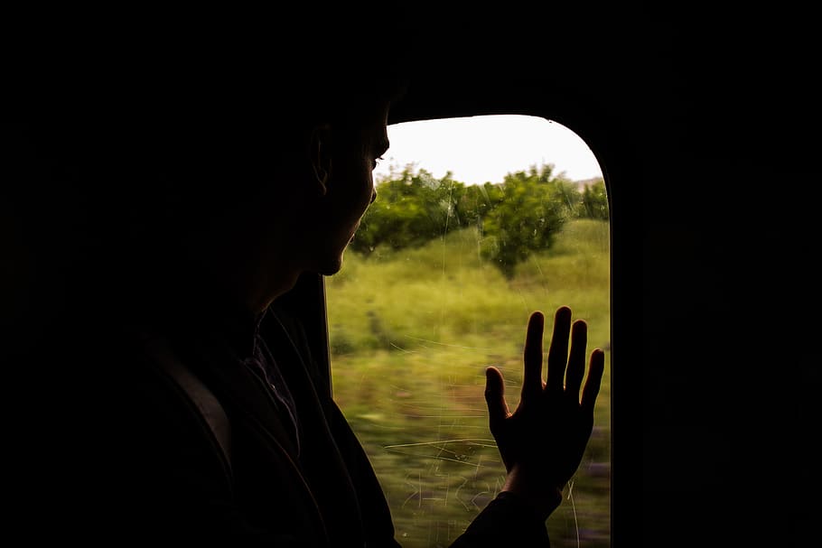 silhouette of person looking on window, person palm on transportation unit window HD wallpaper