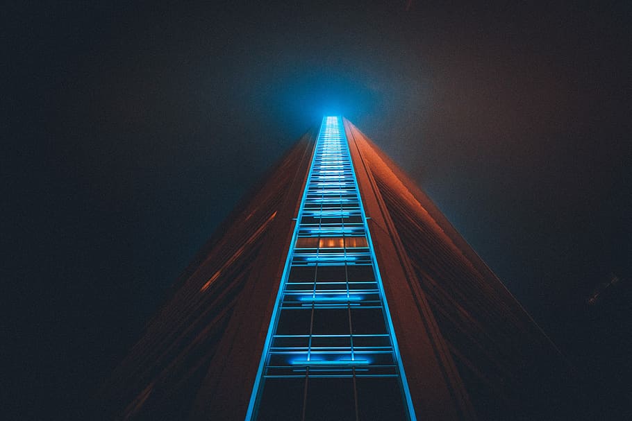 low angle photography of high rise building with lights on, worm's eye view of high-rise building with blue LED lights HD wallpaper