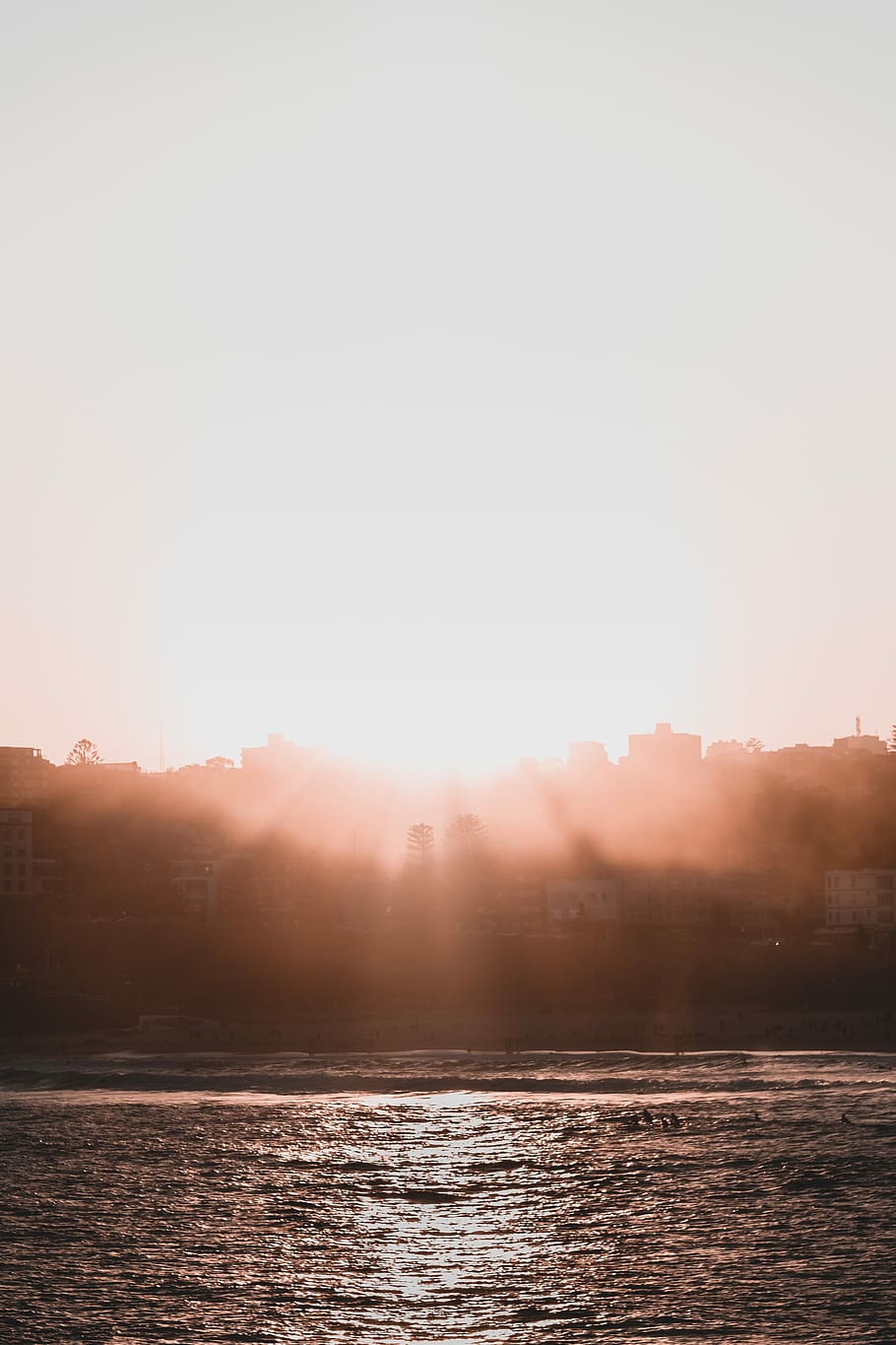 Haze, silhoutte of a city during sunset, water, silhouette, beach HD wallpaper