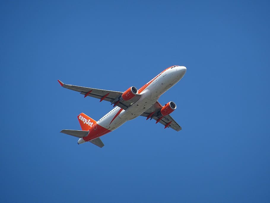 white and red EasyJet airplane on flight, aircraft, close, detail