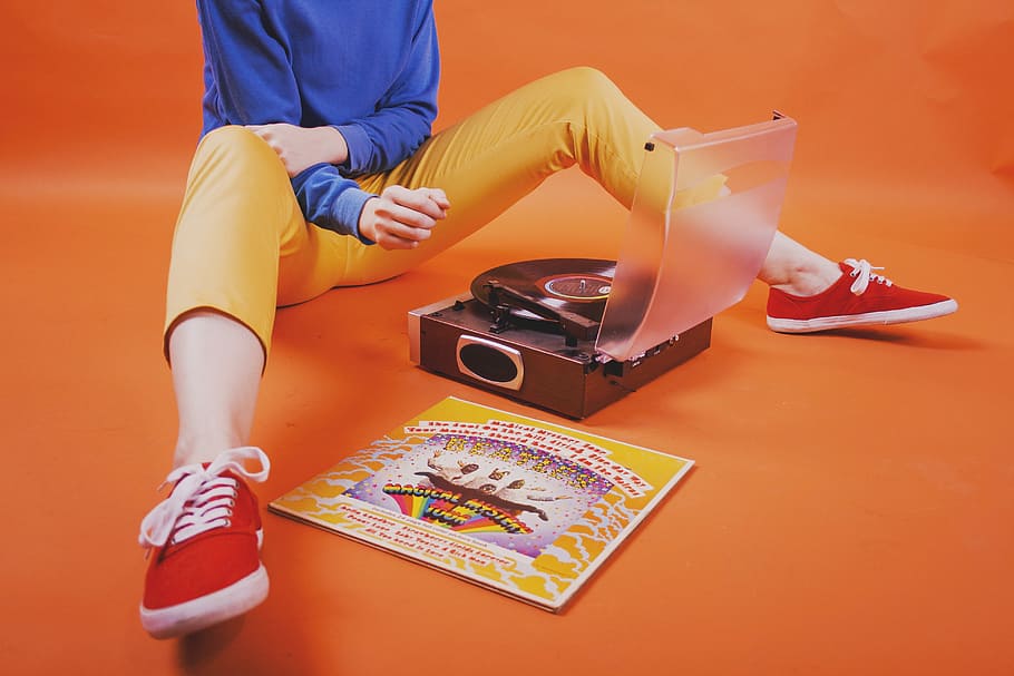 person sitting in front of black turntable, record player, vinyl