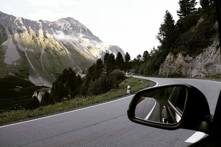 Driving the Albula Pass, car at the road in a distance of a mountain and trees HD wallpaper