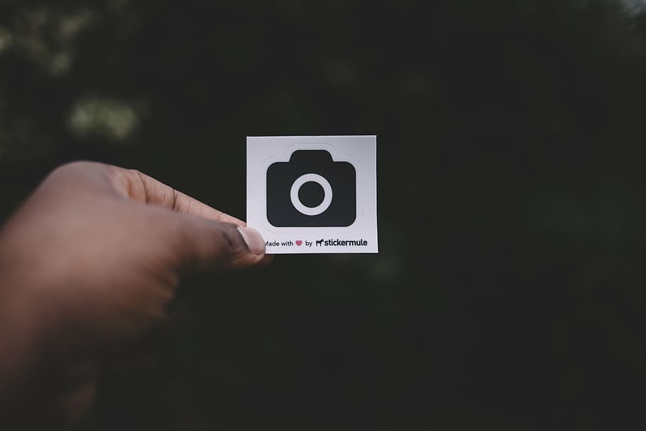person holding white and black camera print paper, dark, outside HD wallpaper