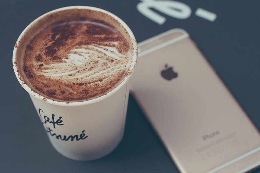 selective focus photo of coffee inside disposable cup beside iPhone 6 HD wallpaper