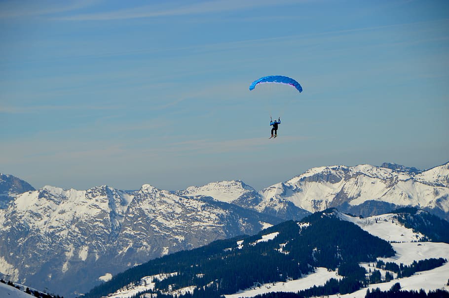 person parachuting above snow covered mountains, person paragliding above snow mountains HD wallpaper