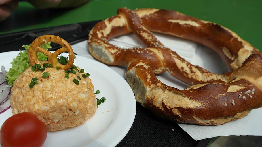 pretzel bread beside plate of rice, beer garden, bavarian snack