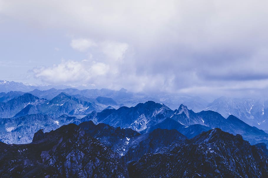aerial photo of snow covered mountain, aerial view photography of mountain under cloudy sky HD wallpaper
