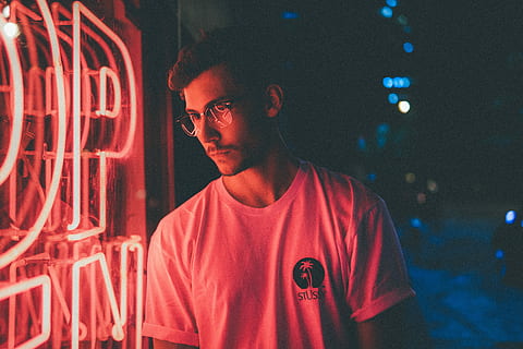 man standing in front of pink neon light signage, man standing near neon signage during night time HD wallpaper
