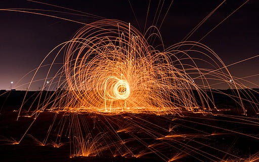 time lapse photography of fireworks display, person doing fire dance during nighttime HD wallpaper