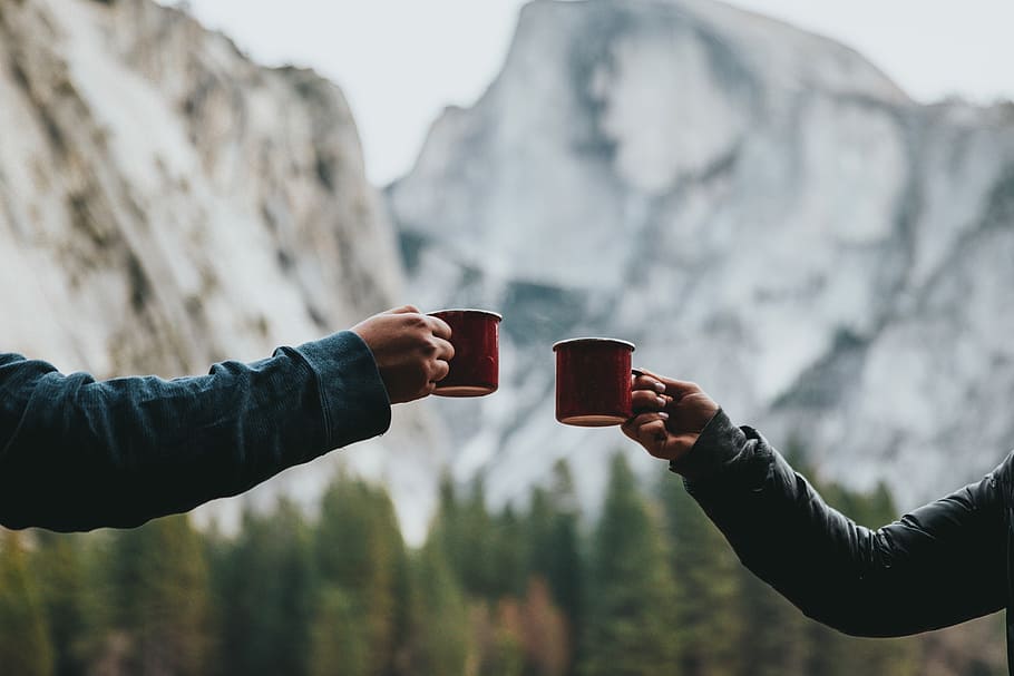 two person holding red mugs, two persons holding red ceramic mugs HD wallpaper