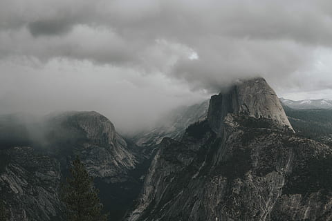 aerial view photography of mountain under clouds, aerial view photography of mountain under cloudy sky HD wallpaper