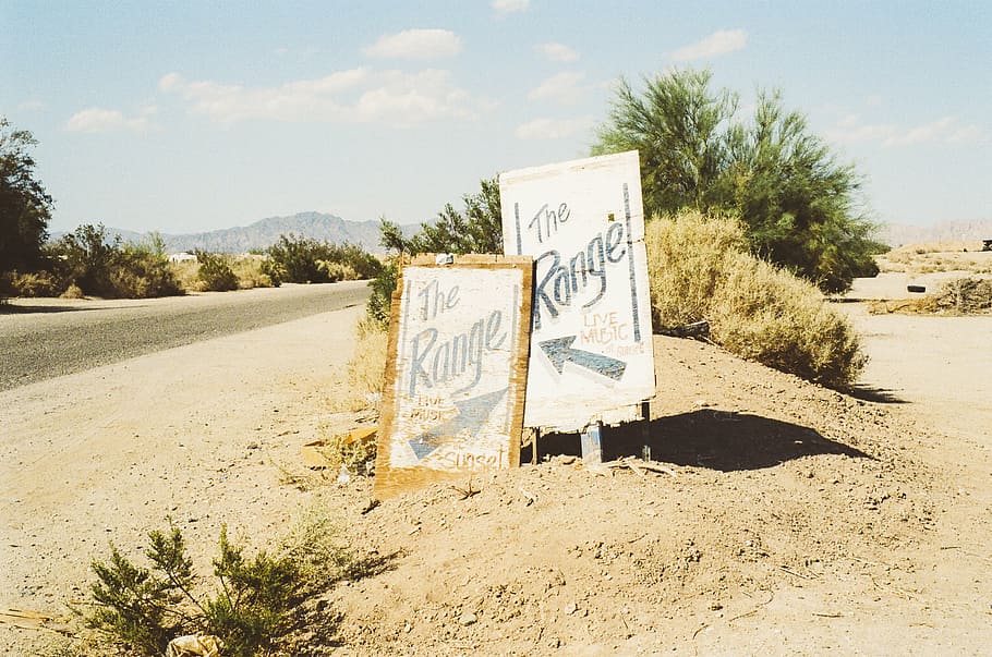 The Range signages, two, placed, gray, sand, near, green, bushes HD wallpaper