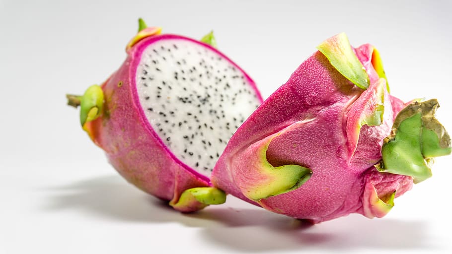 sliced dragon fruit on white surface, Isolated, background, pink