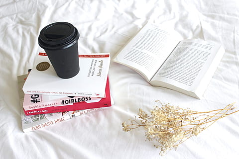 black spill-proof mug on pile of four books beside opened book HD wallpaper