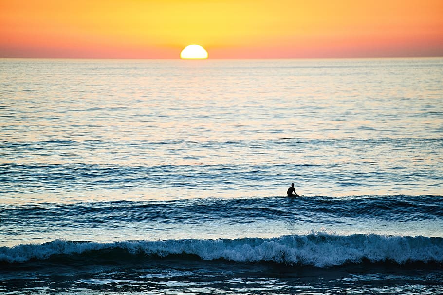 person surfing during sunset, photo of person surfing on beach waves at sunset HD wallpaper