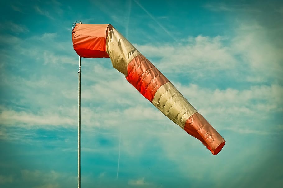 orange and white air hoop, air bag, wind sock, weather, sky, striped