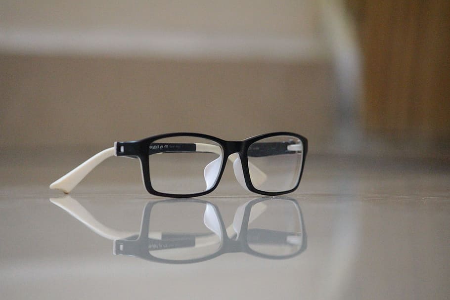 black and white framed eyeglasses on white surface, Spec, Reflection