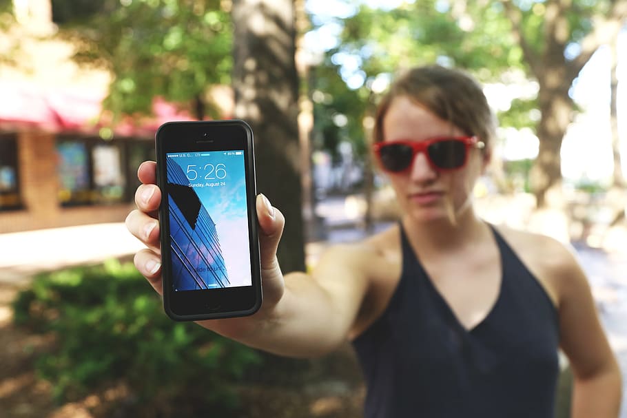 woman wearing black halter top holding black iPhone 5, smartphone HD wallpaper