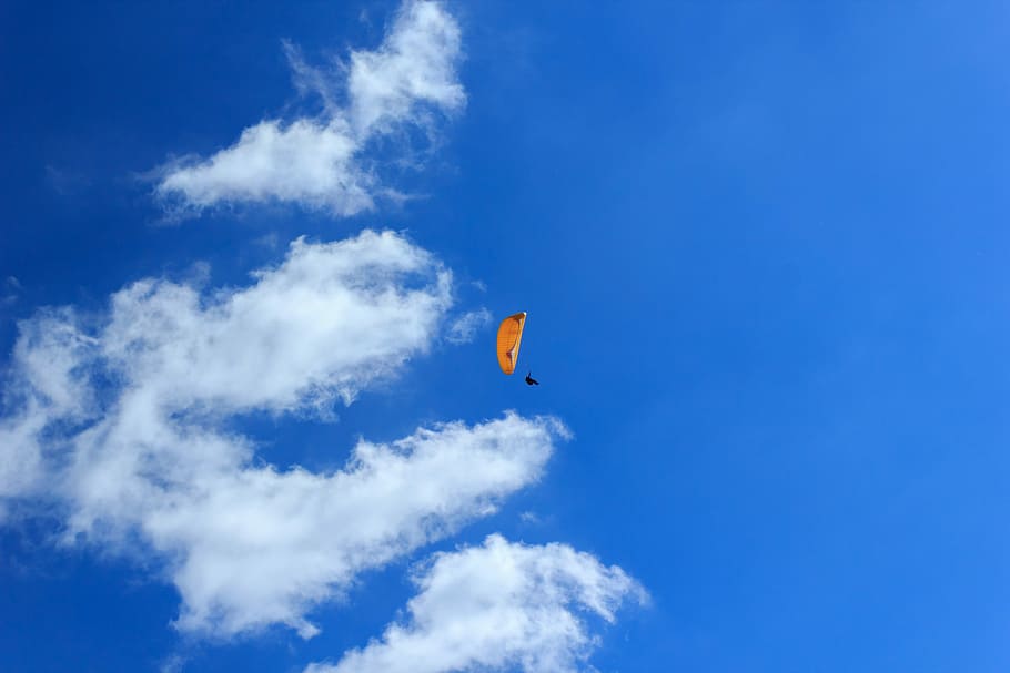 person using parachute during daytime, man paragliding low-angle photography HD wallpaper