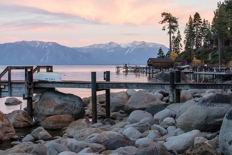 landscape of seashore, brown dock over brown rocks, stone, boulder HD wallpaper