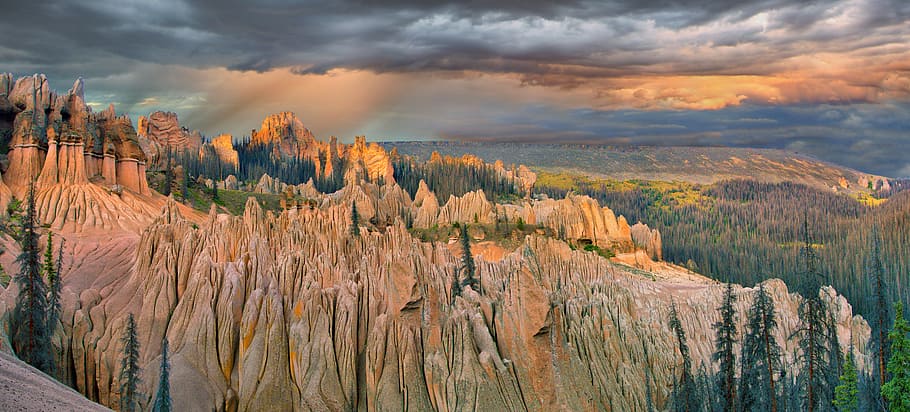 high-angle photography of trees near mountain, rocky mountains during orange sunset HD wallpaper