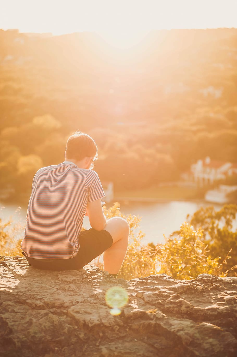 man sitting on rock, man sitting on gray rock sepia photo, cliff HD wallpaper