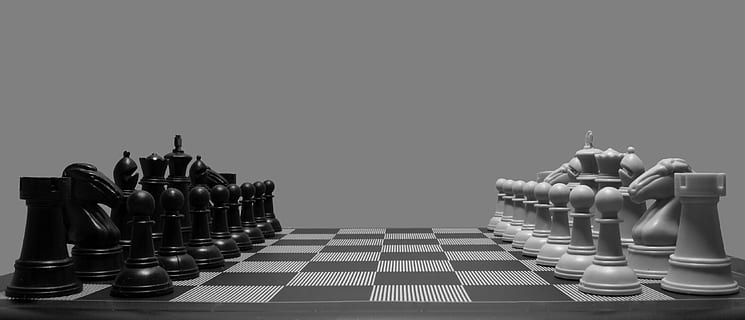 Download Black and White Chess Battle on the Board Wallpaper