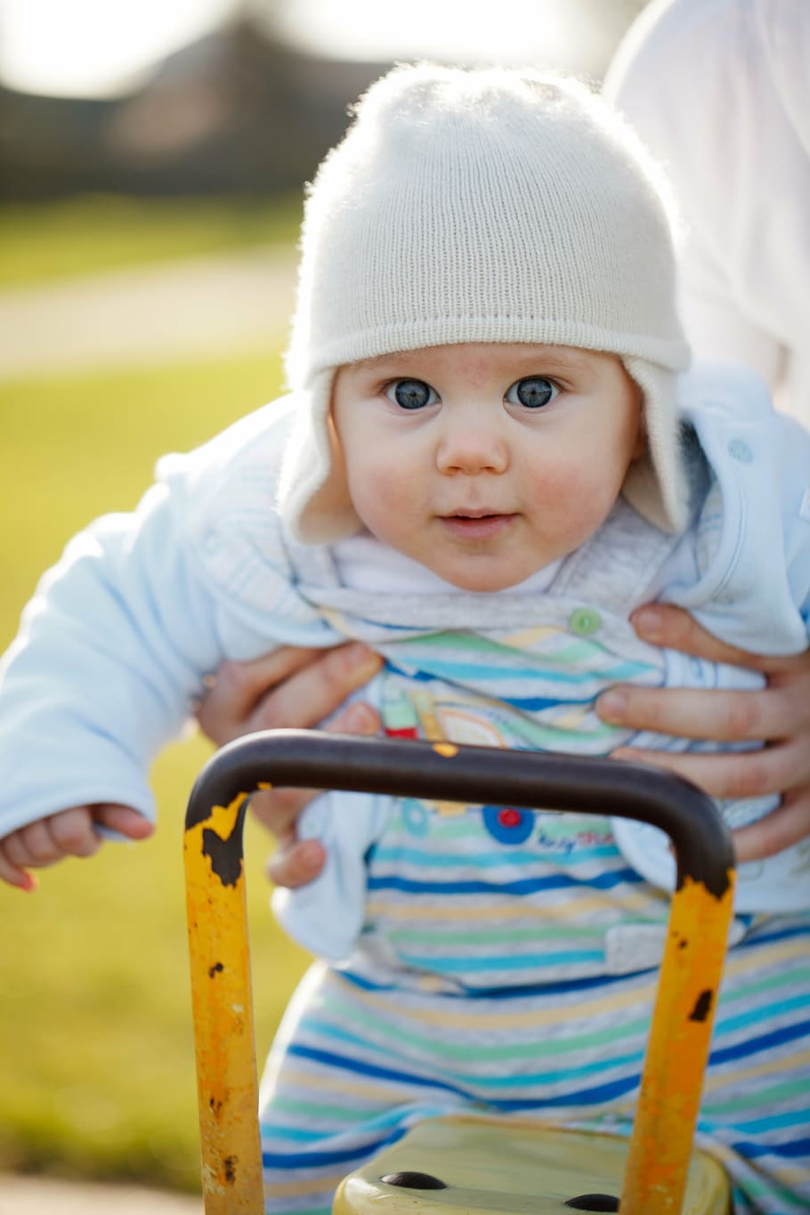 shallow focus photography of person carrying baby, swing, fun