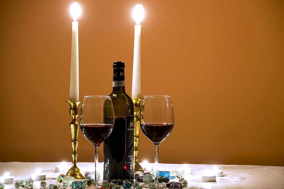 closeup photography of 3/4 full wine bottle in the middle of tall candlestick and wine glasses, HD wallpaper