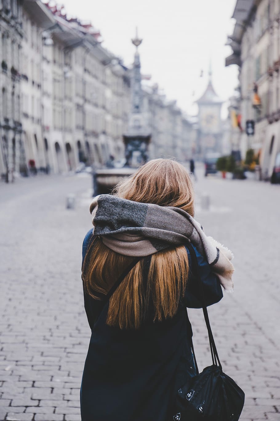 woman wrapped with scarf standing on bricked ground facing empty alley at daytime HD wallpaper