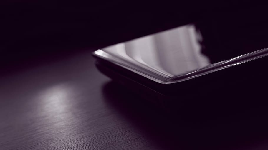 black smartphone turned-off on table, blur, bokeh, closeup HD wallpaper